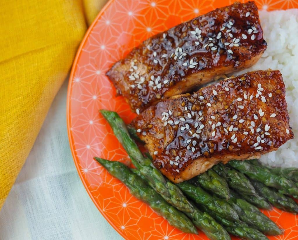 glazed-salmon-on-orange-plate-with-rice-and-asparagus